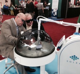 An intrigued dentist watches as Dr. David Fantarella cuts an extracted tooth with Solea.